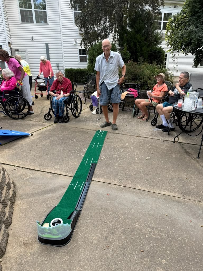 Residents playing on the putting green at Prairie Gardens