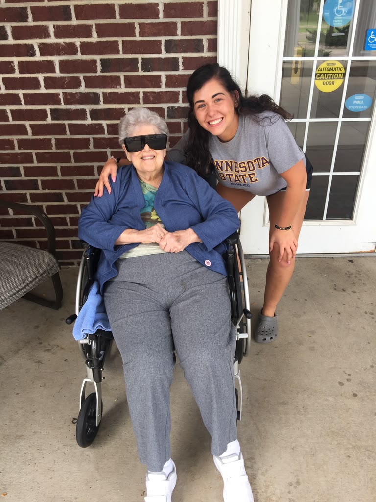 Staff and resident laughing together at Prairie Gardens